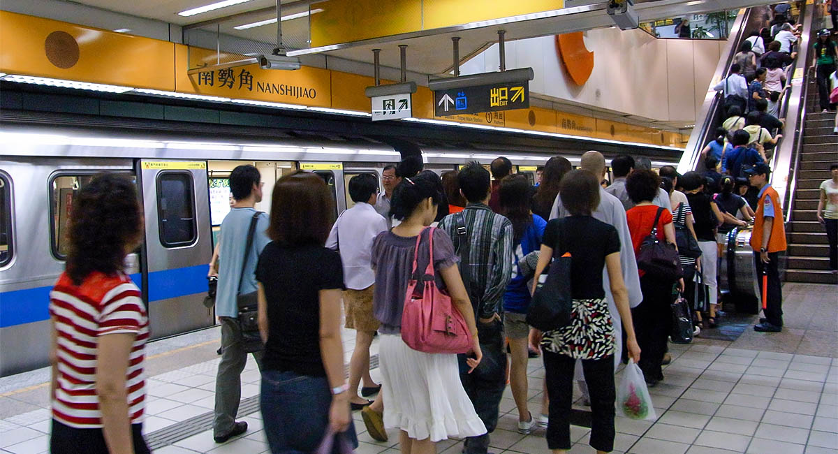 People exiting train in Japanese station