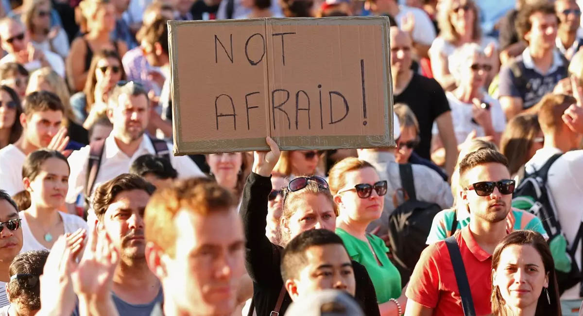 anti-terrorism demonstration, sign with words "not afraid!"
