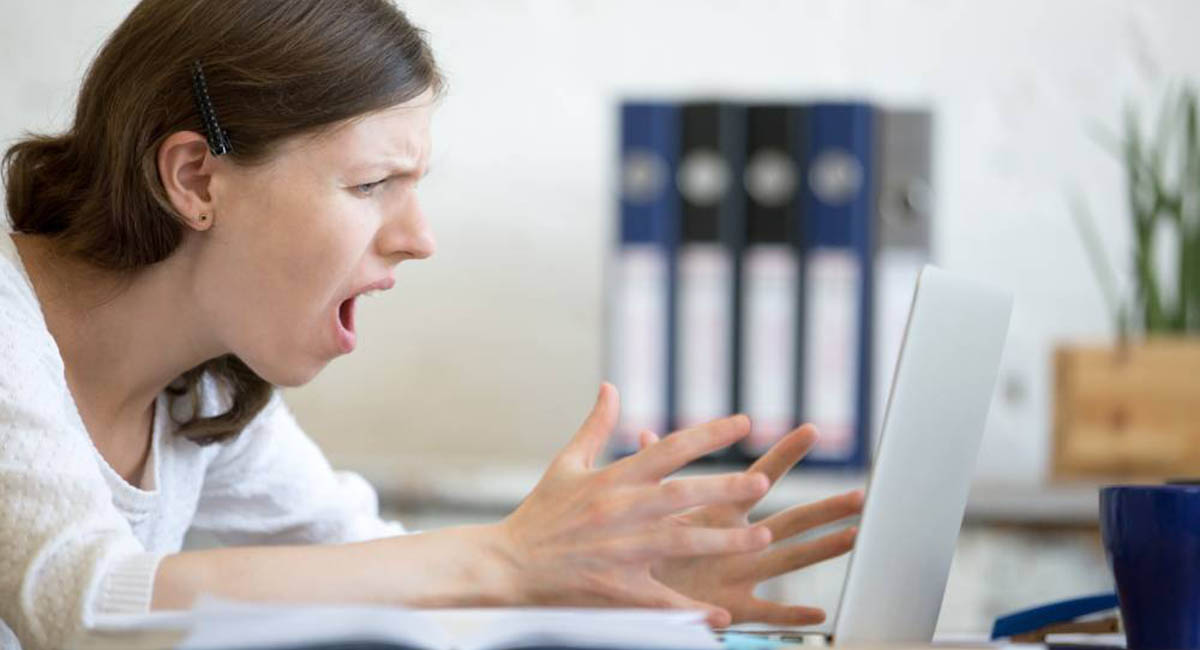 Woman screaming at laptop
