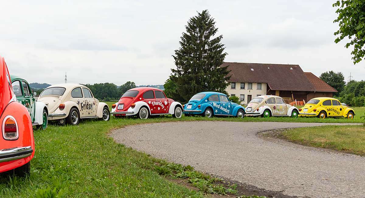 Colorful VW beetles with days of the week on the side