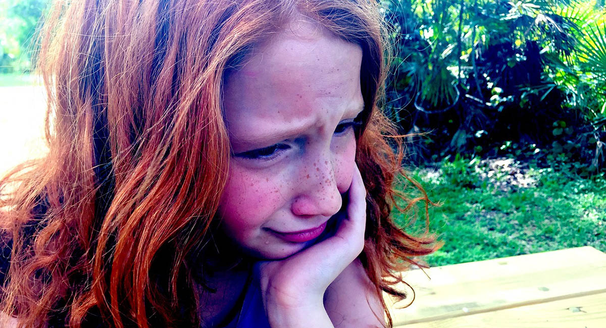 young girl crying, red hair, freckles