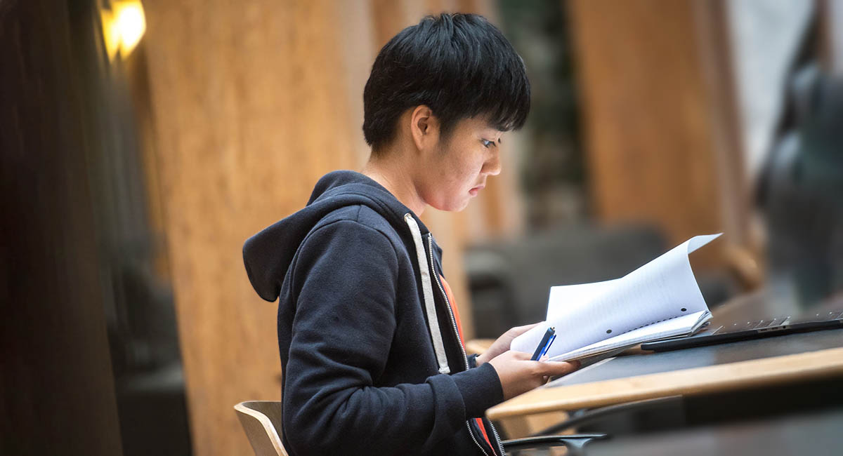 young man sitting a test, Asian
