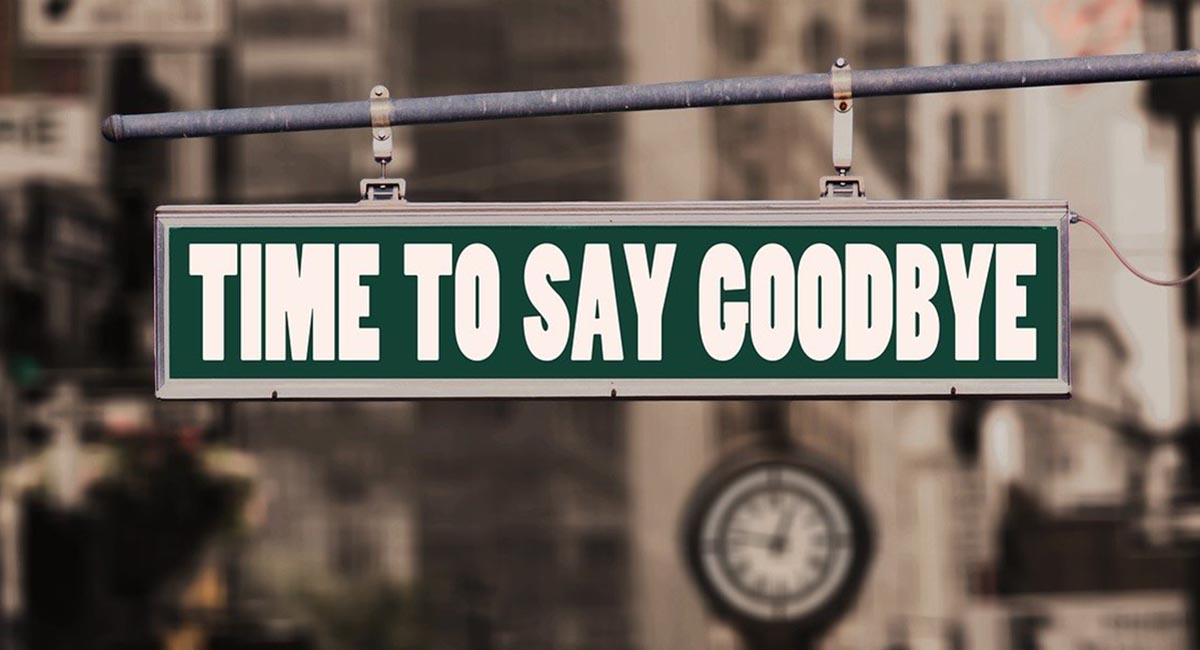 hanging street sign with words "time to say goodbye"