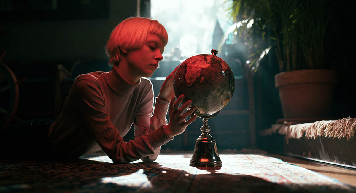 Woman looking at globe, red highlights