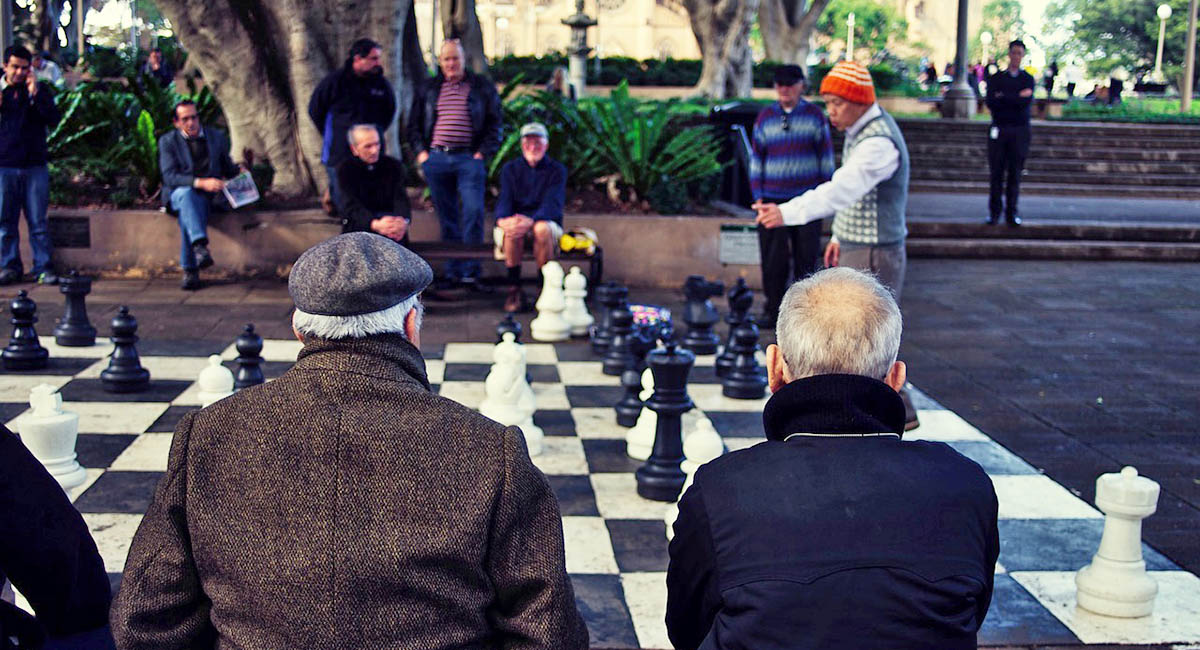 Men playing outdoor chess