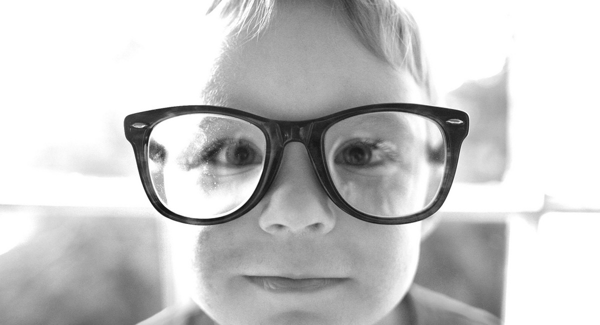 A  boy wearing glasses