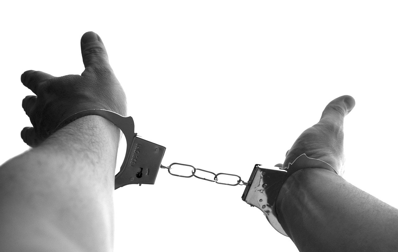 Caught! Man's wrists in handcuffs