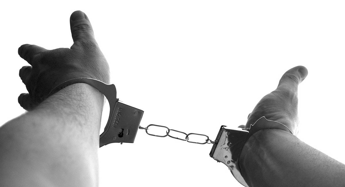 Man's wrists in handcuffs
