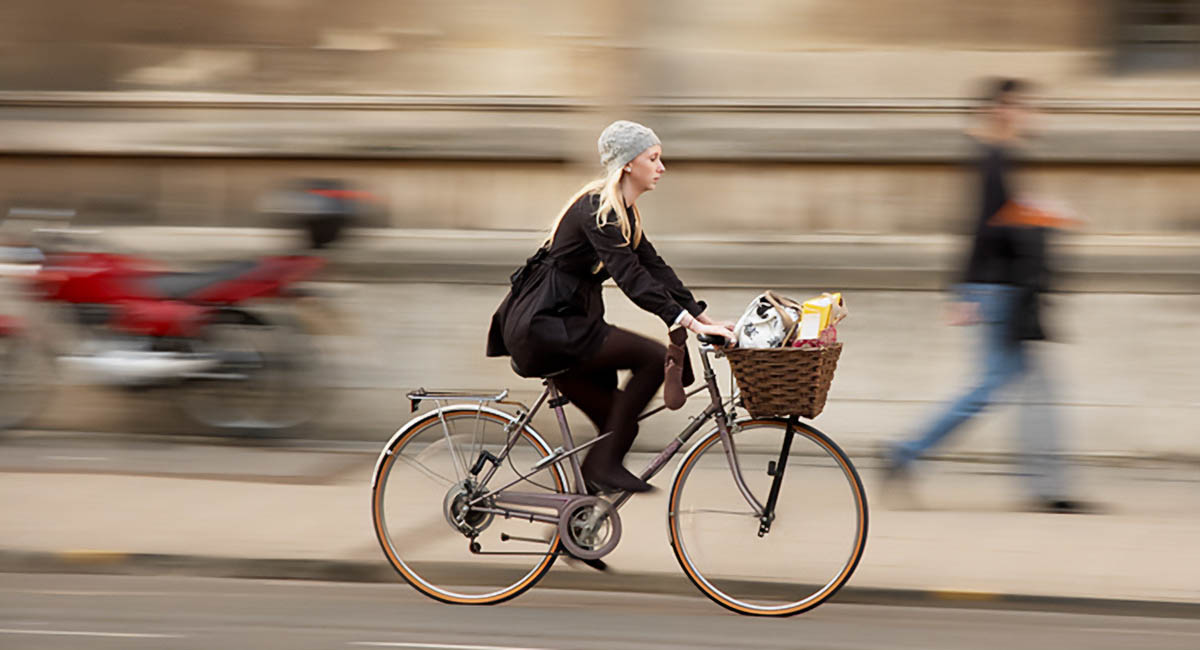 woman riding bike on street, blur