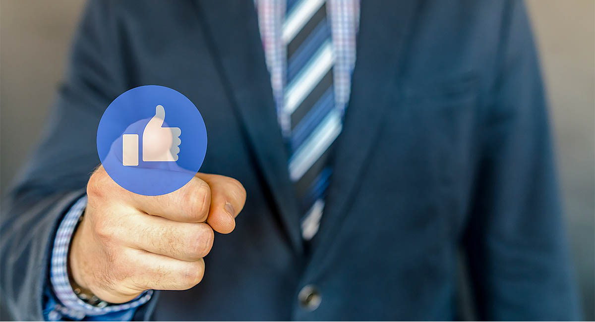 businessman pointing to Facebook like button