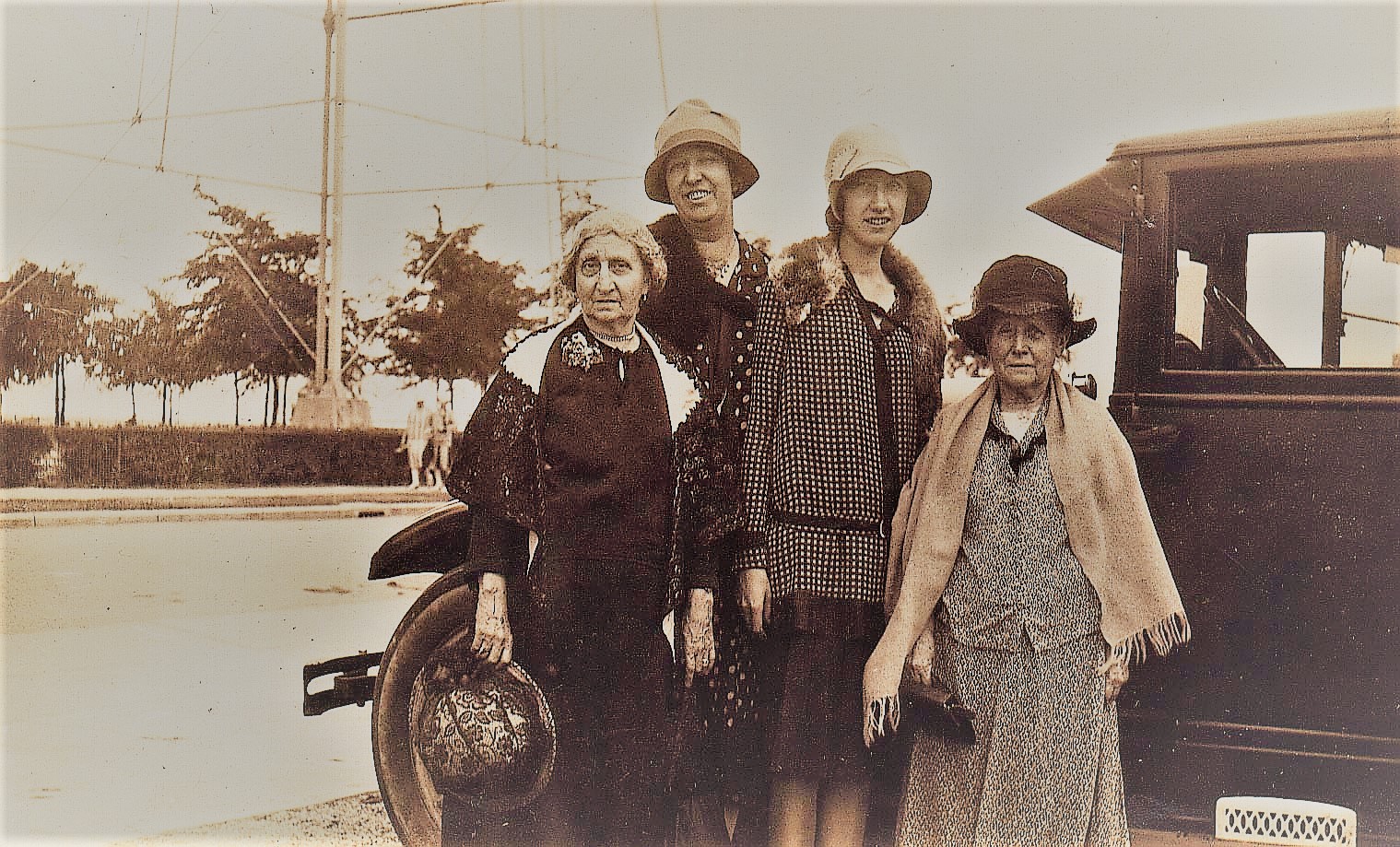 Modern women of the 1920s Four women standing by an automobile in the 1920s