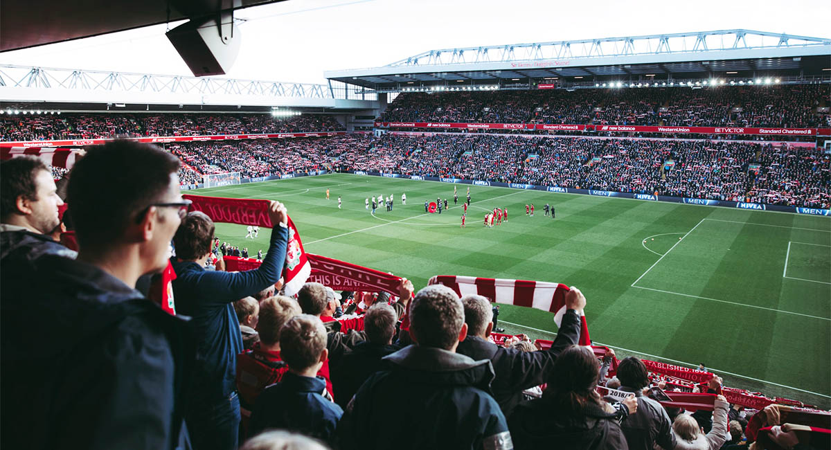 Fans in a stadium watching a Liverpool football game