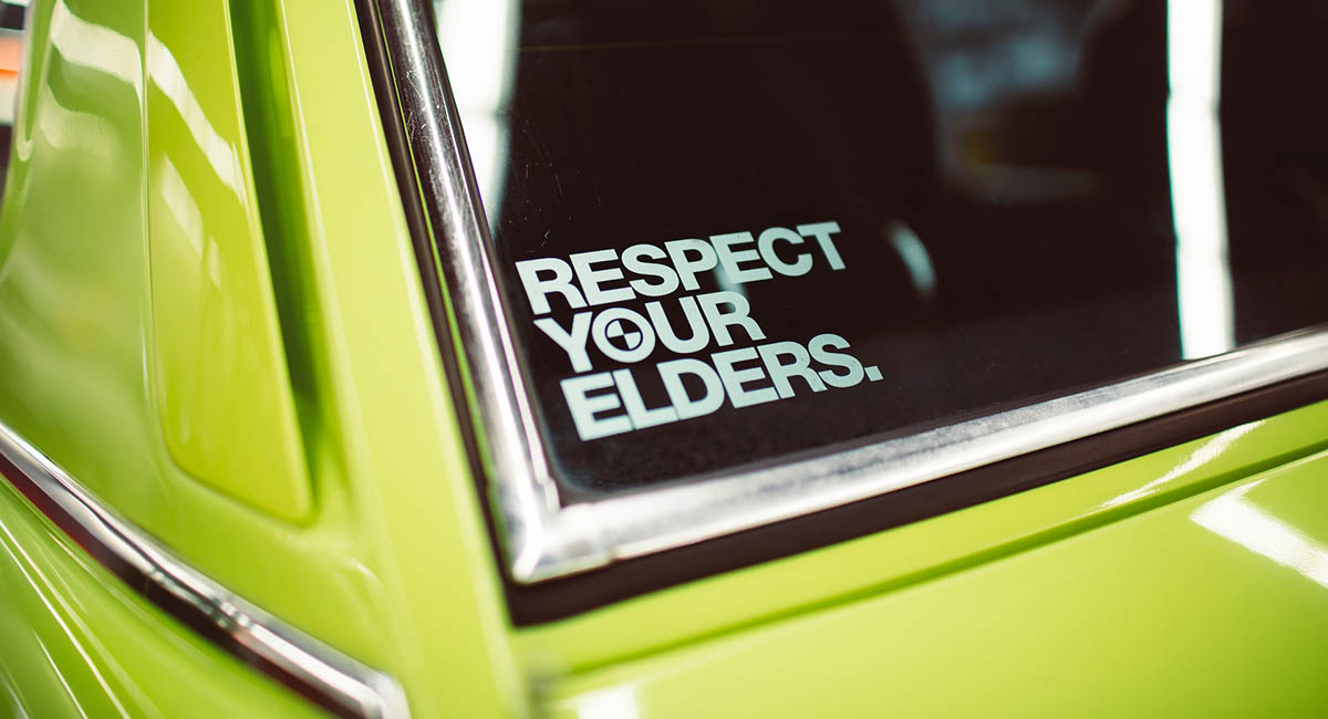 sticker respect elders on green car rear window