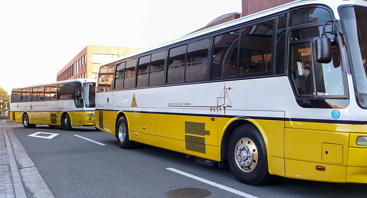 white and yellow school buses in Japan