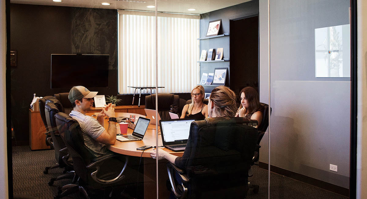 People meeting in a small conference room in casual clothes