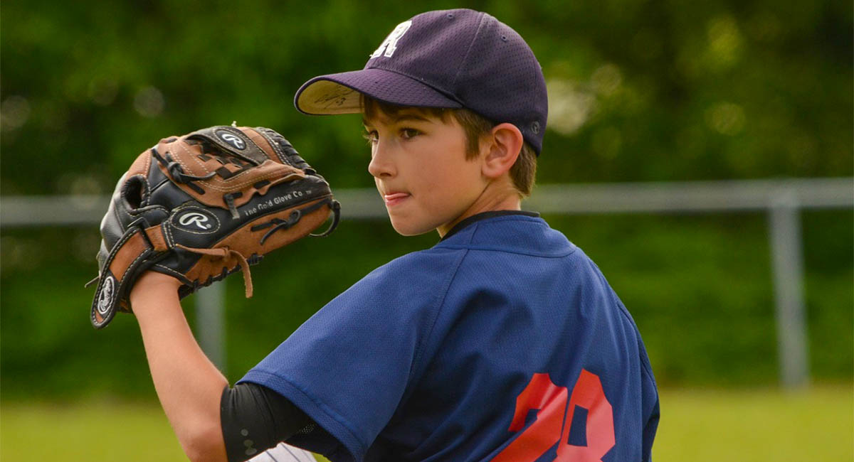 boy in baseball uniform getting ready to pitch