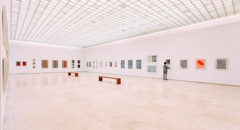 Man in art gallery, light, alone