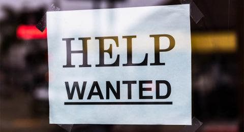 Help Wanted sign on shop door