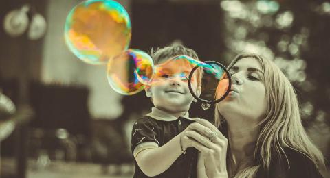 boy with mother blowing bubbles