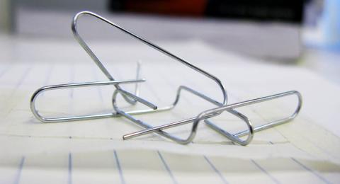 bent paperclips on notepaper