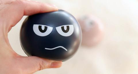 black stress ball with angry face