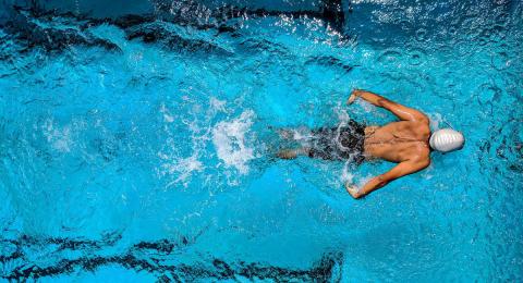 Man doing the breaststroke in a swimming pool