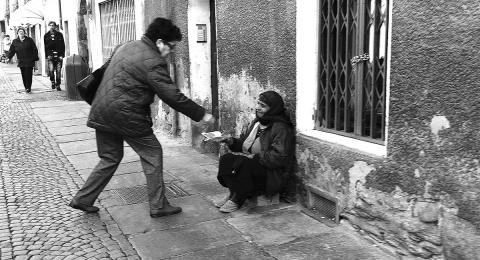 Man giving money to a beggar on the street