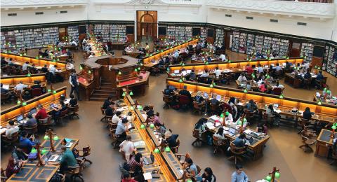 Overhead view of students at work in a large university library