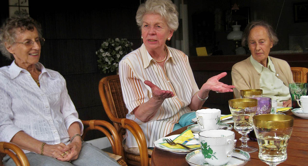 three older White women at a table with tea