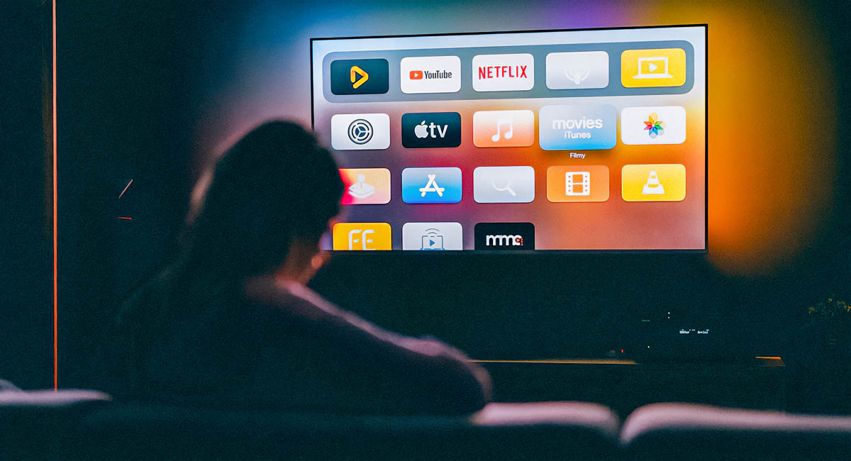 person watching tv screen with streaming apps