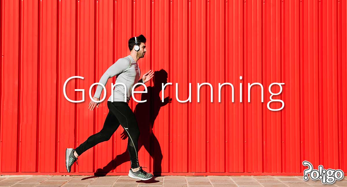 Man running in front of red wall