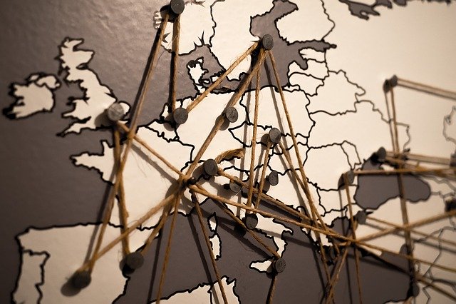 Travel around the world Map of the world with pushpins and string marking different locations